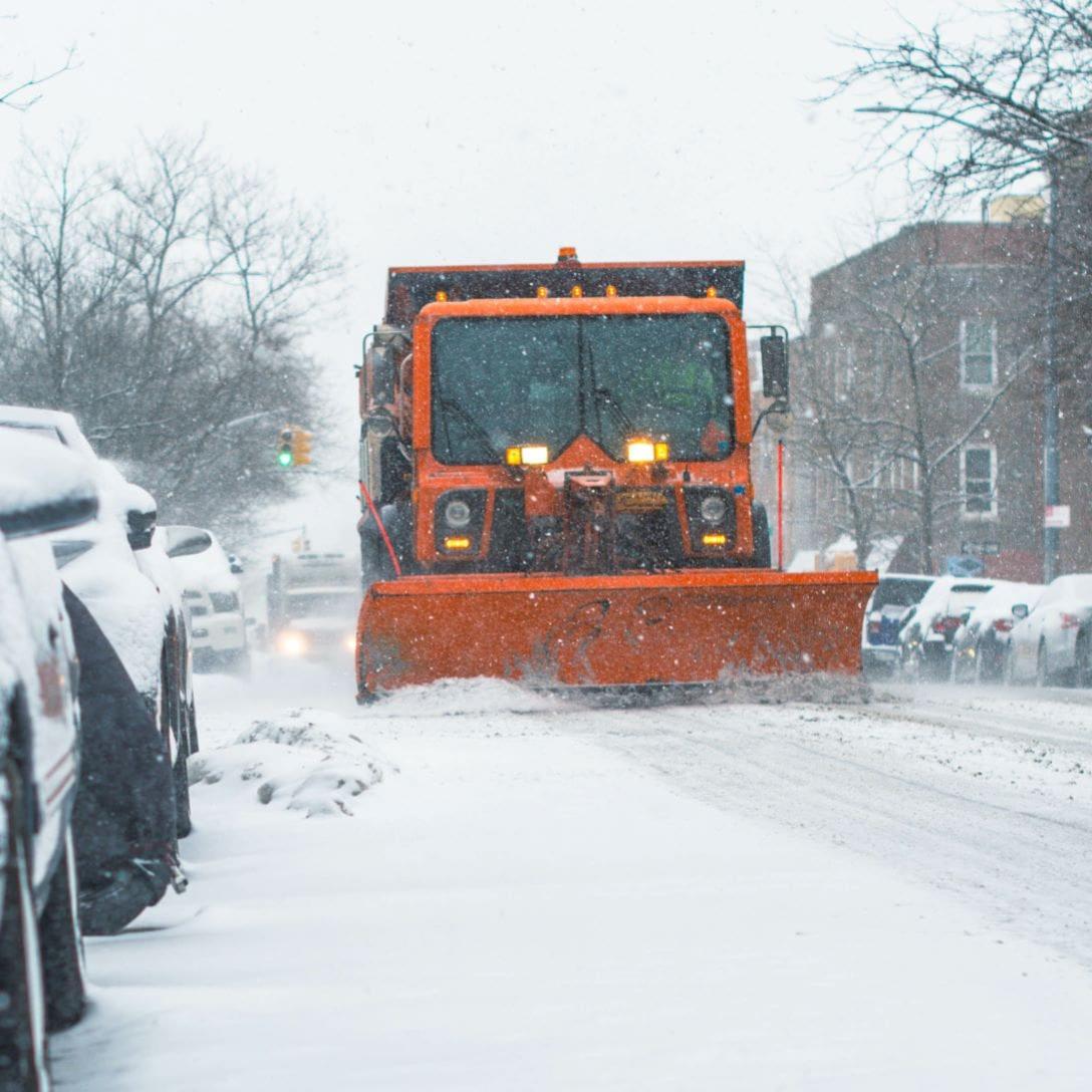 Snow plow clearing a street